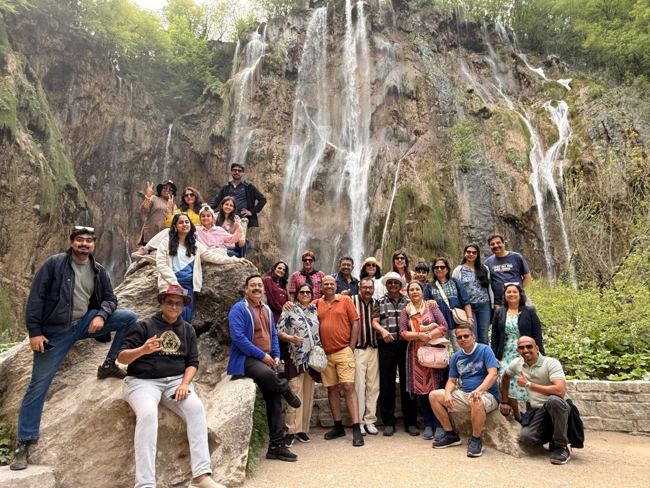 Cluster Tours and Travels group enjoying a waterfall journey